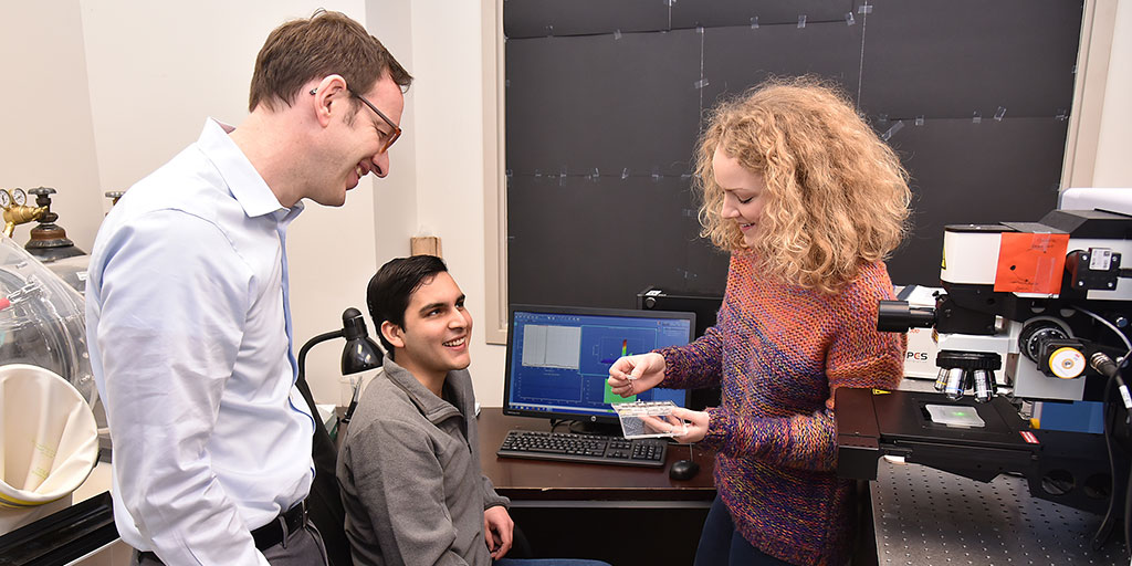 Maik Lang, Raul Palomares, and Jessica Bishop prepare a sample for Raman Spectroscopy.